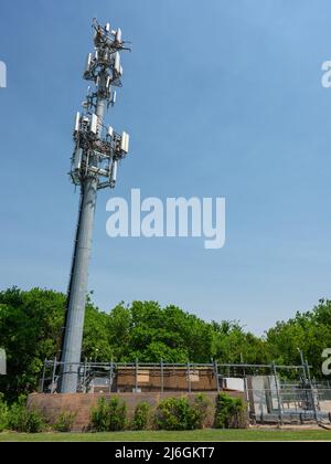 Ein Mobilfunkturm und eine Basis-Transceiver-Station versorgen 4G und 5G mobile Breitbandverbindungen im Vorort Fort Worth, Texas. Stockfoto