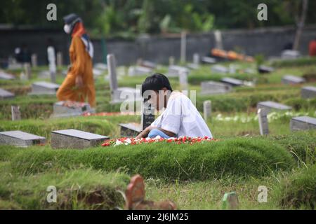 2. Mai 2022, Jakarta, Jakarta Capital Special Region, Indonesien: Die Traurigkeit eines Bewohners während des Gebets, während er traurigerweise während einer schweren Pilgerfahrt auf dem Covid-19 Friedhof, Rorotan, Cilincing, Jakarta, Indonesien, beklagt. Die diesjährige Eid al-Fitr-Feier wurde von einer Reihe von Muslimen genutzt, um Wallfahrten zu machen und für ihre Familien zu beten, die gemäß dem Covid-19-Protokoll begraben wurden. (Bild: © Kuncoro Widyo Rumpoko/Pacific Press via ZUMA Press Wire) Stockfoto