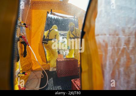 Dekontamination von Biohazard-Team des medizinischen Notdienstes in Schutzanzügen. Stockfoto