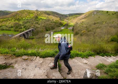 Ein Bergwanderer, der den Weg in Monsal Head, Derbyshire, Großbritannien, hinaufgeht Stockfoto