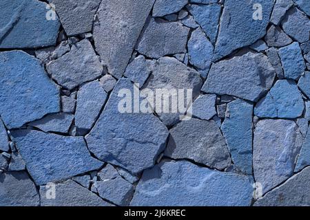 Blauer Stein Wand Hintergrund. Felswand Textur Foto. Oberfläche natürlich. Detail einer Steinmauer mit unterschiedlicher Größe von Steinen. Tonned Stockfoto