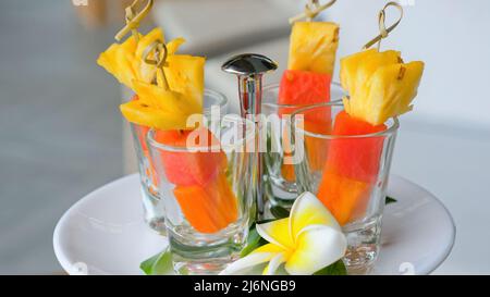 Frische Sommerfrüchte auf Spiessen, Ananas, Wassermelone, Papaya auf Bambusstäbchen Stockfoto