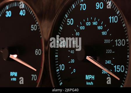 Tachometer im Armaturenbrett bei voller Geschwindigkeit im beleuchteten Nachtmodus Stockfoto