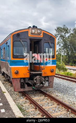 Ein Zug fährt in einen Bahnhof und wartet in Thailand auf Fahrgäste Stockfoto