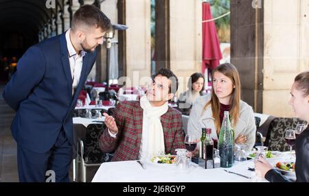 Verärgerte Gäste mit Manager im Restaurant Stockfoto