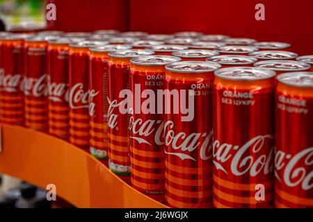 Ukraine, Vinnytsia, 25. Mai 2020 – viele rote Eisengläser mit Coca Cola stehen in einem Schaufenster Stockfoto