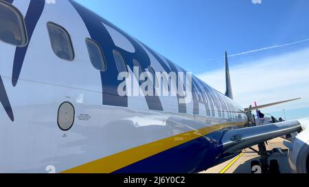 Passagiere, die am Flughafen Frankfurt Hahn - HAHN, DEUTSCHLAND - 20. APRIL 2022 auf ihren Flug mit einem Ryanair-Flugzeug warten Stockfoto