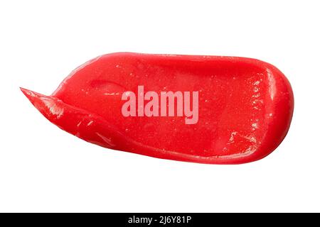 Schönheitsmaske mit Farbmuster verschmiert, isoliert auf Weiß. Rote Gesichtslotion Zahnbürste Feuchtigkeitscreme Textur. Hautpflegeprodukt, Zahnbürste für Kinder, Enthaarung Stockfoto