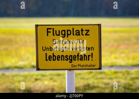 deutsches Warnschild. Kein Zutritt zum Flugplatz für Unbefugte, Lebensgefahr! Der Platzhalter. Stockfoto