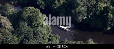 Luftaufnahme eines Bootes, das einen Fluss im Amazonas in Brasilien überquert. Combu Island, Ilha do Combu, Belém, Pará State, Amazon, Brasilien. 2013. Stockfoto