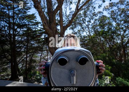 Junge Frau mit Fernglas am Coit Tower in San Francisco | Lifestyle Tourism Stockfoto