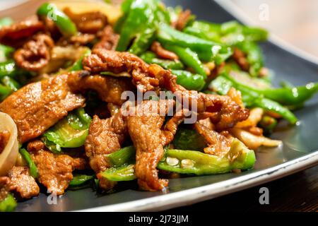 Ein Teller mit köstlichen und würzigen Hunan-Gerichten, gebratenes Schweinefleisch mit Chili Stockfoto