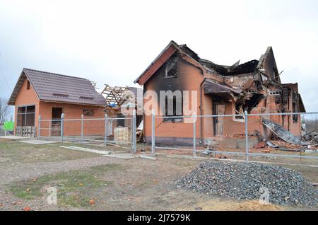 Myla, Region Kiew, Ukraine - 03. April 2022: Beschädigtes Haus in der Nähe der Autobahn Shutomyr in der Region Kiew infolge der russischen Invasion. Stockfoto