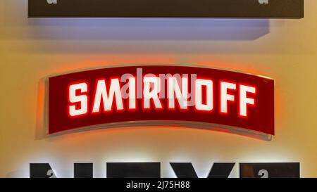 Belgrad, Serbien - 28. April 2022: Berühmtes Smirnoff Vodka von der Firma Diageo Leuchtendes Schild an der Bar Wall. Stockfoto