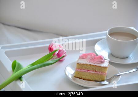 Muttertag, Liebe für Mutter. Morgen mit Sorge für Mama. Ein Tablett mit Kaffee und Kuchen auf dem Bett. Postkarte geschrieben von einem Kind Tochter oder Sohn Ich liebe Mutter PR Stockfoto