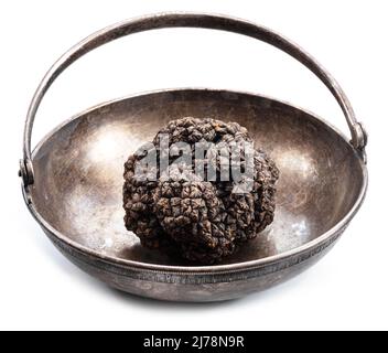 Schwarze Wintertrüffel in der altmodischen Blechschüssel isoliert auf weißem Hintergrund. Stockfoto