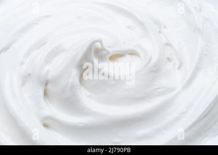 Cremig pic und Wellen in Joghurt oder Creme Oberfläche. Draufsicht. Stockfoto