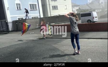 Falmouth Cornwall, Großbritannien 07.. Mai 2022. Eine heldenhaft stellvertretende Bürgermeisterin der Stadt Falmouth, die voll von der Bürokette ist und ihre „Rainbow Pride“-Flagge hält, sieht, wie sie in einem Steak-Restaurant auf dem Event Square der Stadt Falmouth auf ein Feuer zuläuft. Die Big Gay Pride Unterhaltungsstätte musste für die Sicherheit der anwesenden Massen evakuiert werden. Ratsmitglied Kirsty Edwards ist ein eifriger Befürworter der Minderheitenrechte. Falmouth Cornwall Robert Taylor Alamy Live News Stockfoto