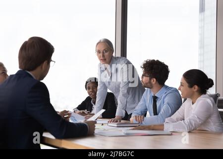 Selbstbewusste Senior Corporate Mentor Lehrgruppe von Praktikanten Stockfoto