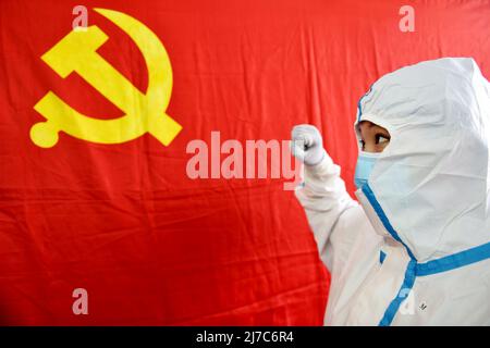ZHANGJIAKOU, CHINA - 11. FEBRUAR 2020 - Eine Krankenschwester schwört vor einer Parteiflagge in Zhangjiakou, Provinz Hebei, China, 11. Februar 2020. Stockfoto