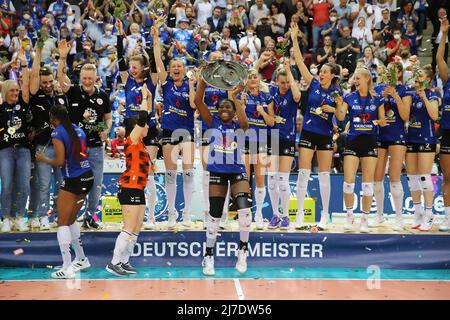 08. Mai 2022, Baden-Württemberg, Stuttgart: Volleyball, Frauen: Bundesliga, Allianz MTV Stuttgart - SC Potsdam, Meisterschaftsrunde, Finale, Spieltag 5. Krystal Riels (M) von Allianz MTV Stuttgart hält die Meisterschaftspokal und feiert den Titel mit dem Stuttgarter Team. (An "Stuttgarter Frauen-Volleyballmannschaft sichert sich deutschen Meistertitel") Foto: Herbert Rudel/Pressefoto Rudel/dpa Stockfoto