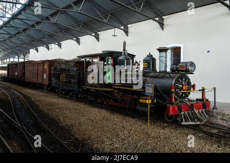 Eine deaktivierte Baldwin Locomotive arbeitet Nº 60 mit einigen dahinter angebrachten Schienenfahrzeugen, die am Bahnhof Sao Joao del Rei ausgestellt sind. Stockfoto