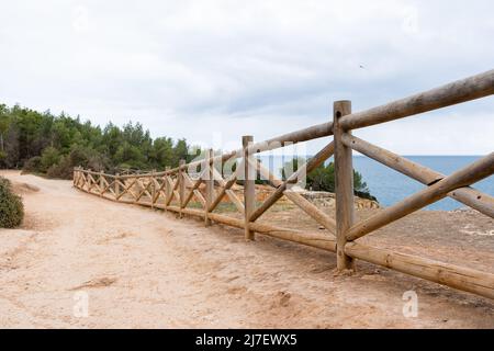 Zaun in der Nähe des Felsbogens in Portugal. Landschaft von Praia da Marinha an der Algarve, Portugal. Stockfoto