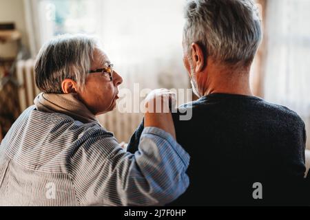 Zwei traurige, verliebte alte Menschen sitzen zu Hause zusammen. Seniorenpflege lieben Konzept Stockfoto