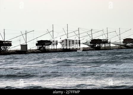 Adriaküste von Venetien, Strand Sottomarina. Alte Fischmaschinen. Schlechtes Wetter, Wind- und Seesturm trafen die Küste. Stockfoto