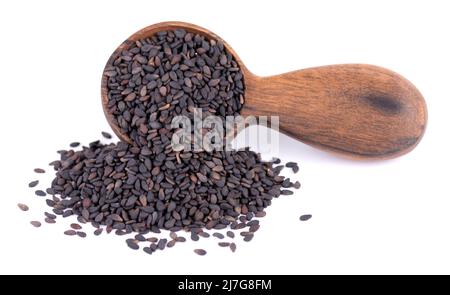 Schwarze Sesamsamen in Holzlöffel, isoliert auf weißem Hintergrund. Bio-Gewürz. Stockfoto