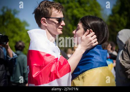 Warschau, Polen. 09.. Mai 2022. Demonstranten, die mit ukrainischer und weißrussischer Flagge gewickelt sind, werden während des Protestes gesehen. Hunderte von Ukrainern und polnischen Aktivisten protestierten auf einem Warschauer Friedhof vor Soldaten der Roten Armee, die während des Zweiten Weltkriegs starben Der russische Botschafter in Polen, Sergej Andreev, wurde von Demonstranten, die gegen den Krieg in der Ukraine waren, bei einer jährlichen Veranstaltung zum Tag des Sieges zum Gedenken an das Ende des Zweiten Weltkriegs mit roter Farbe angestrichen Botschafter Sergej Andreew kam am Tag des Sieges auf dem sowjetischen Soldatenfriedhof an, um Blumen zu legen, aber der Diplomat und seine Delegation waren gezwungen, das Gebiet in Begleitung zu verlassen Stockfoto