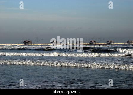 Adriaküste von Venetien, Strand Sottomarina. Alte Fischmaschinen. Schlechtes Wetter, Wind- und Seesturm trafen die Küste. Stockfoto