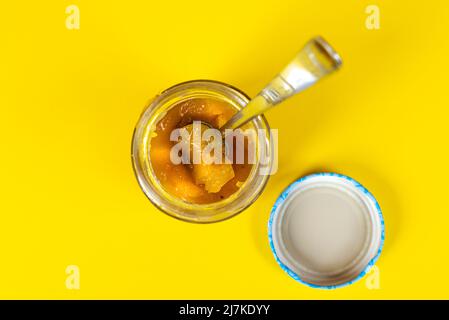 Der Teelöffel in einem Glas Marmelade Stockfoto