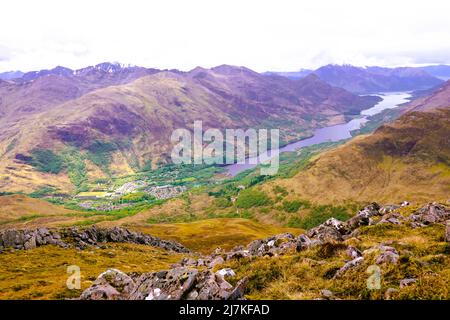 Blick auf das schottische Highland-Dorf Kinlochleven mit Loch Leven im Hintergrund. Stockfoto