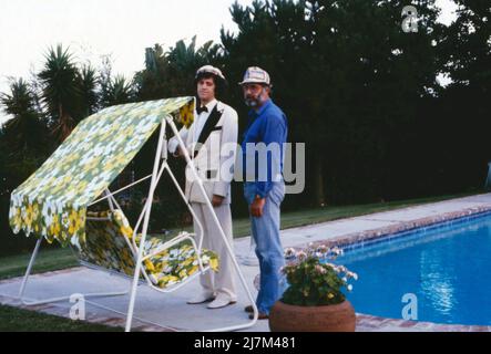 Hollywood, ich komme, deutscher Fernsehfilm, Deutschland, 1980, Im Bild: Ilja Richter und Regisseur Ralf Gregan während der Dreharbeiten in Zsa Zsa Gabors Villa in Beverly Hills, hier am Swimmingpool. Hollywood, ich komme, deutscher Fernsehfilm, Deutschland, 1980, Ilja Richter und Regisseur Ralf Gregan während der Dreharbeiten in der Villa von Zsa Zsa Gabor in Beverly Hills, hier am Schwimmbad. Stockfoto