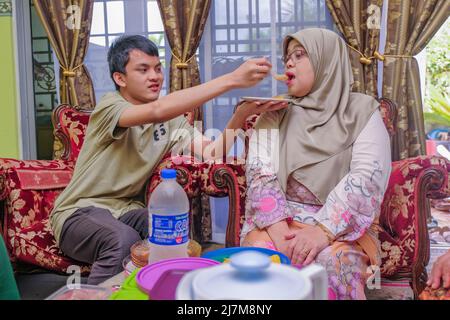 Batu Pahat, Malaysia - 4.. Mai 2022: Eine Familie Hari Raya Aidilfitri Eid-UL-Fitr Essen und eine Festlichkeit in Malaysia Familie, Glück und Vergebung Stockfoto