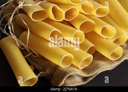 Cannelloni Pastaröhrchen isoliert auf dunklem Hintergrund. Italienisches Essen. Stockfoto