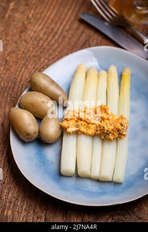 Weißer Spargel auf einem blauen Teller Stockfoto