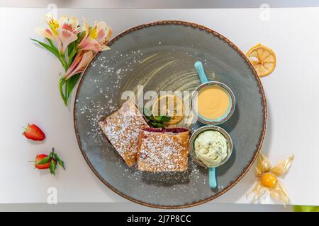 Apfelstrudel mit Honig und Eis und frischen Beeren Stockfoto