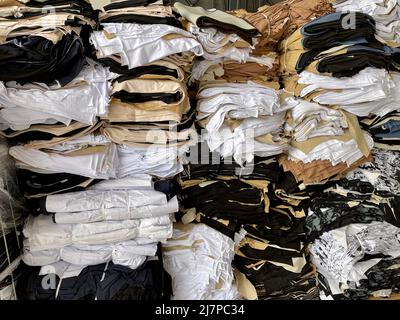 Stapel aus Baumwollstoff. Fabrik für Schneiderbekleidung. Lager textiler Hintergrund. Stockfoto