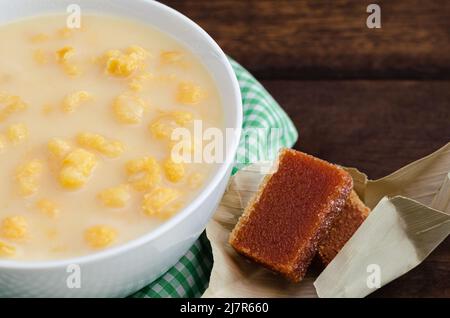 Traditionelles kolumbianisches Essen namens Mazamorra, basierend auf gekochtem Mais, der in Milch aufgelöst wurde, begleitet von süßem Guava (genannt Bocadillo). Dunkler Hintergrund. Stockfoto