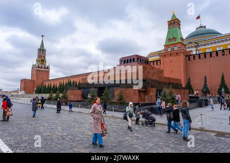 Moskau, Russland - 10. April 2022: Menschen und Touristen laufen um den Spasskaya-Turm des Kremls in Moskau, Russland Stockfoto