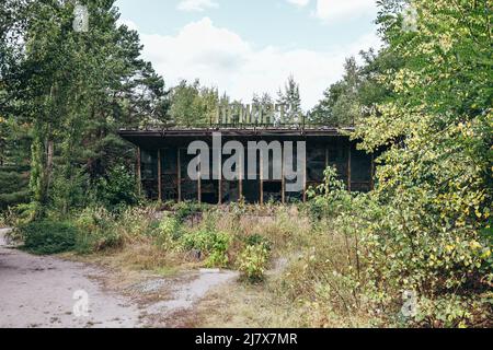 Frontfenster eines verlassenen radioaktiven sowjetischen Gebäudes mit dem Schild mit der Aufschrift „Pripjat“ in der Tschernobyl-Sperrzone Ukraine Stockfoto
