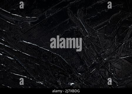Makro-Nahaufnahme von glänzend schwarzer Acrylfarbe auf Leinwand. Abstrakt hohe Auflösung Vollformat texturierten Leinwand Hintergrund. Speicherplatz kopieren. Stockfoto