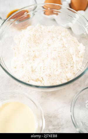 Gemessene Zutaten in Glasschüsseln zum Backen von Eiernang-Scones. Stockfoto