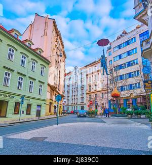 PRAGUE, CZECH REPUBLIC - MARCH 5, 2022: The architectural ensemble of Odboru Street with modern and historic houses and sculpture of Hanging Umbrella Stock Photo