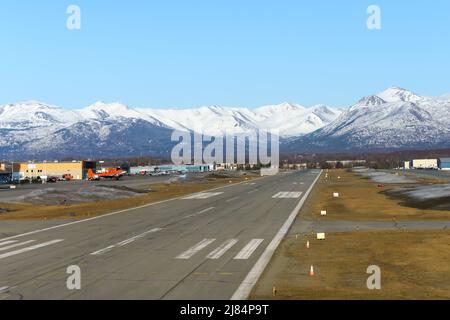 Merrill Field Flughafen in Anchorage, hauptsächlich für die allgemeine Luftfahrt genutzt. Merrill Feldbahn mit Bergen dahinter. Stockfoto
