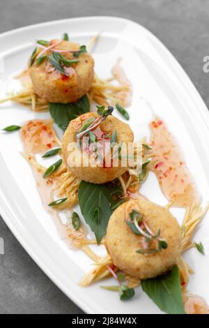Traditionelle thailändische Krabbenkuchen mit Chilisauce im modernen restaurant in bangkok Stockfoto
