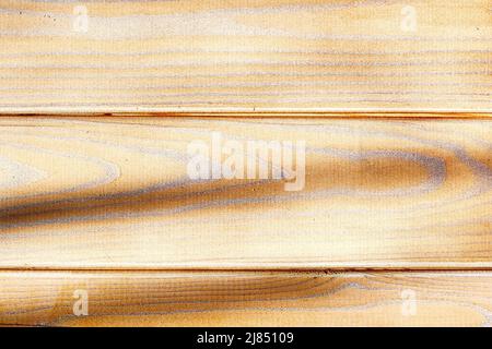 Strukturierte Holzoberfläche mit braunen Planken und Schatten. Hintergrundmuster Stockfoto