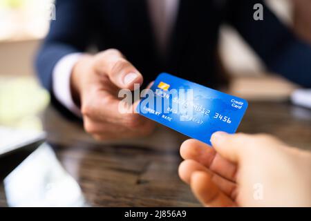 Geschäftstransaktion Mit Kreditkarte. Man Hand Hält Debitkarte Stockfoto